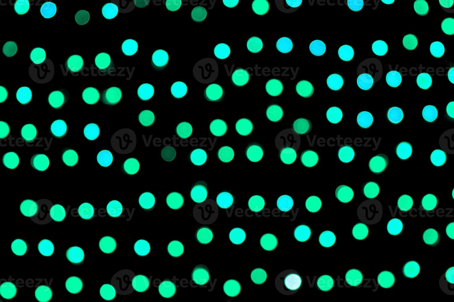 Unfocused abstract colourful bokeh black background. defocused and blurred many round blue light photo