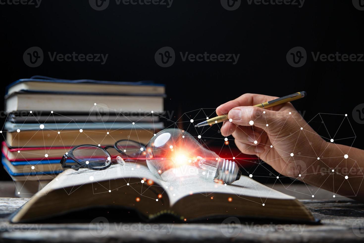 Light bulbs and books. Concept of reading books, knowledge, and searching for new ideas. Innovation and inspiration, Creativity with twinkling lights, the inspiration of ideas. photo
