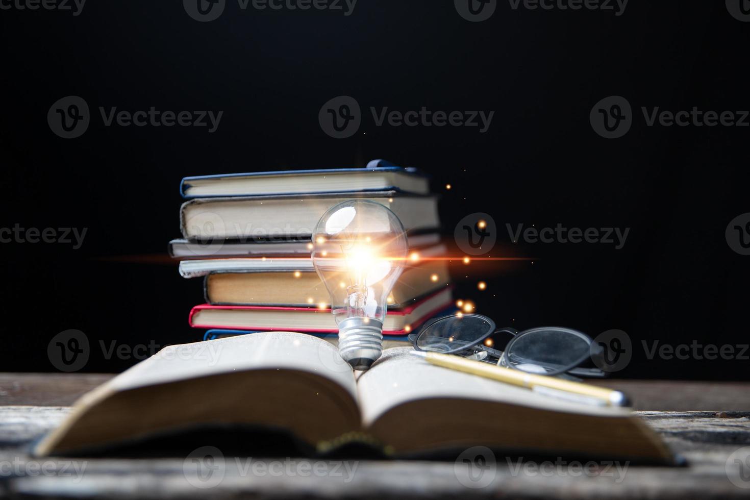 Light bulbs and books. Concept of reading books, knowledge, and searching for new ideas. Innovation and inspiration, Creativity with twinkling lights, the inspiration of ideas. photo
