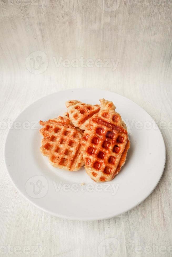 Croissant Waffle or Croffle with chocolate sauce served in box and white background photo