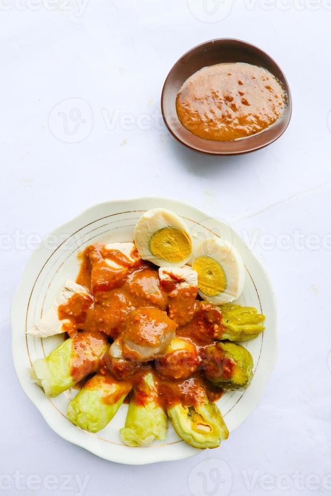 siomay or dumplings is traditional indonesian- china food with peanut sauce. siomay made dumplings, tofu, cabbage rolls, potatoes, bitter gourd and peanut sauce. dim sum, shaomai, siu maai, shaomai photo