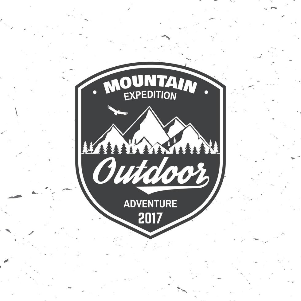 Vintage typography design with soaring eagle and mountain silhouette. vector