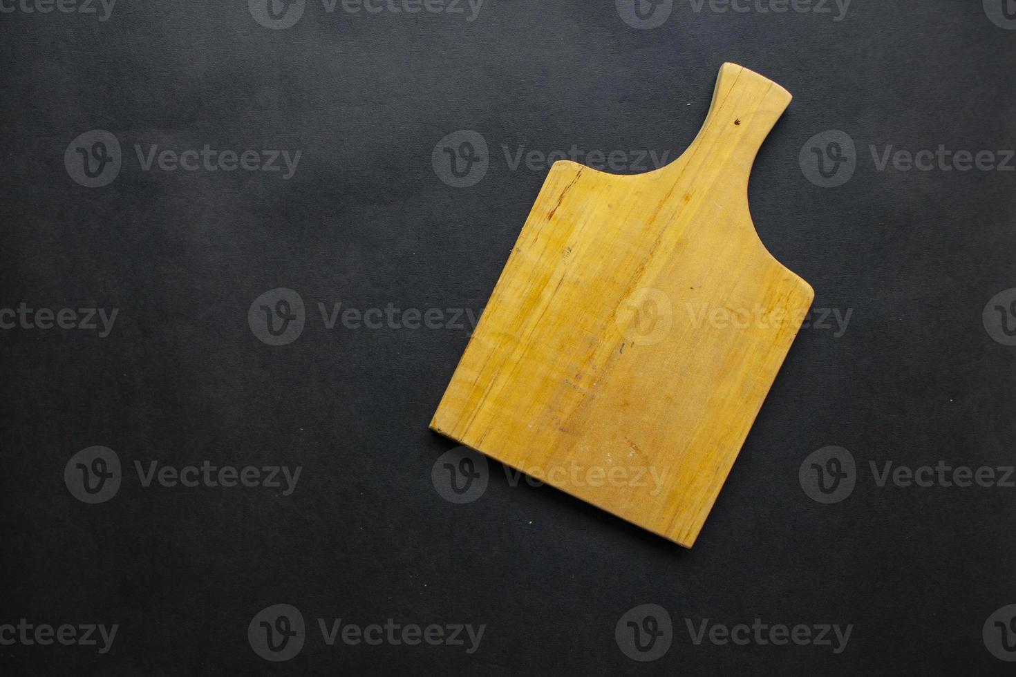 Cutting board from wood for cooking. wooden cutting board on black background. Top view with copy space for text. Menu, recipe, flat lay mockup, banner background photo