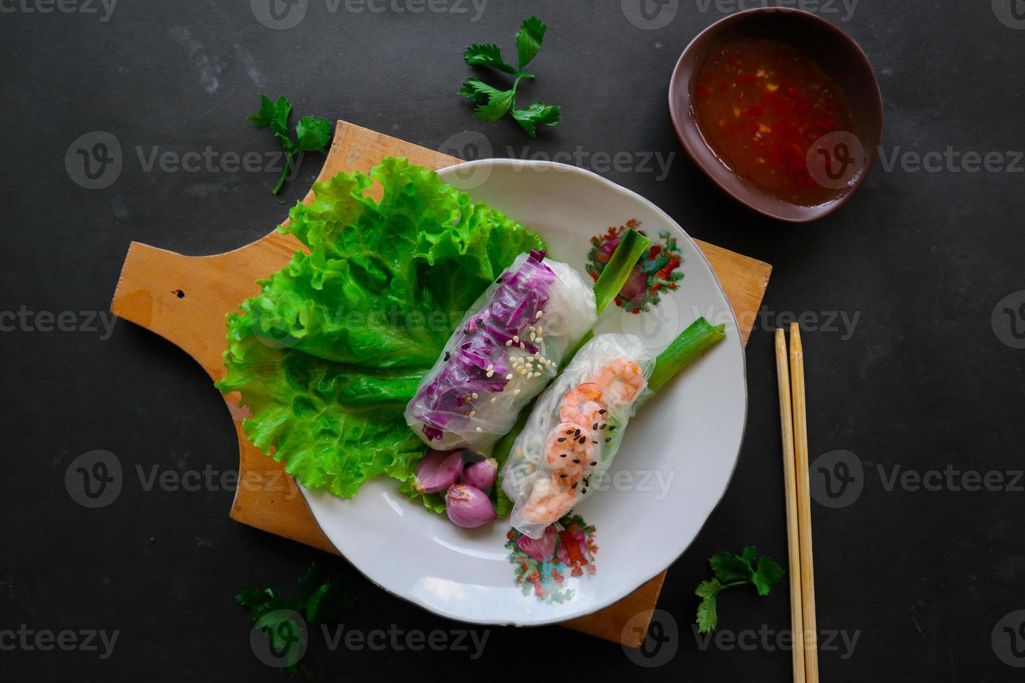 Goi cuon is a traditional spring roll from Vietnam , Vietnamese food, made from meat, shrimp, vegetables, vermicelli, wrapped in rice paper or banh trang. served with sauce photo