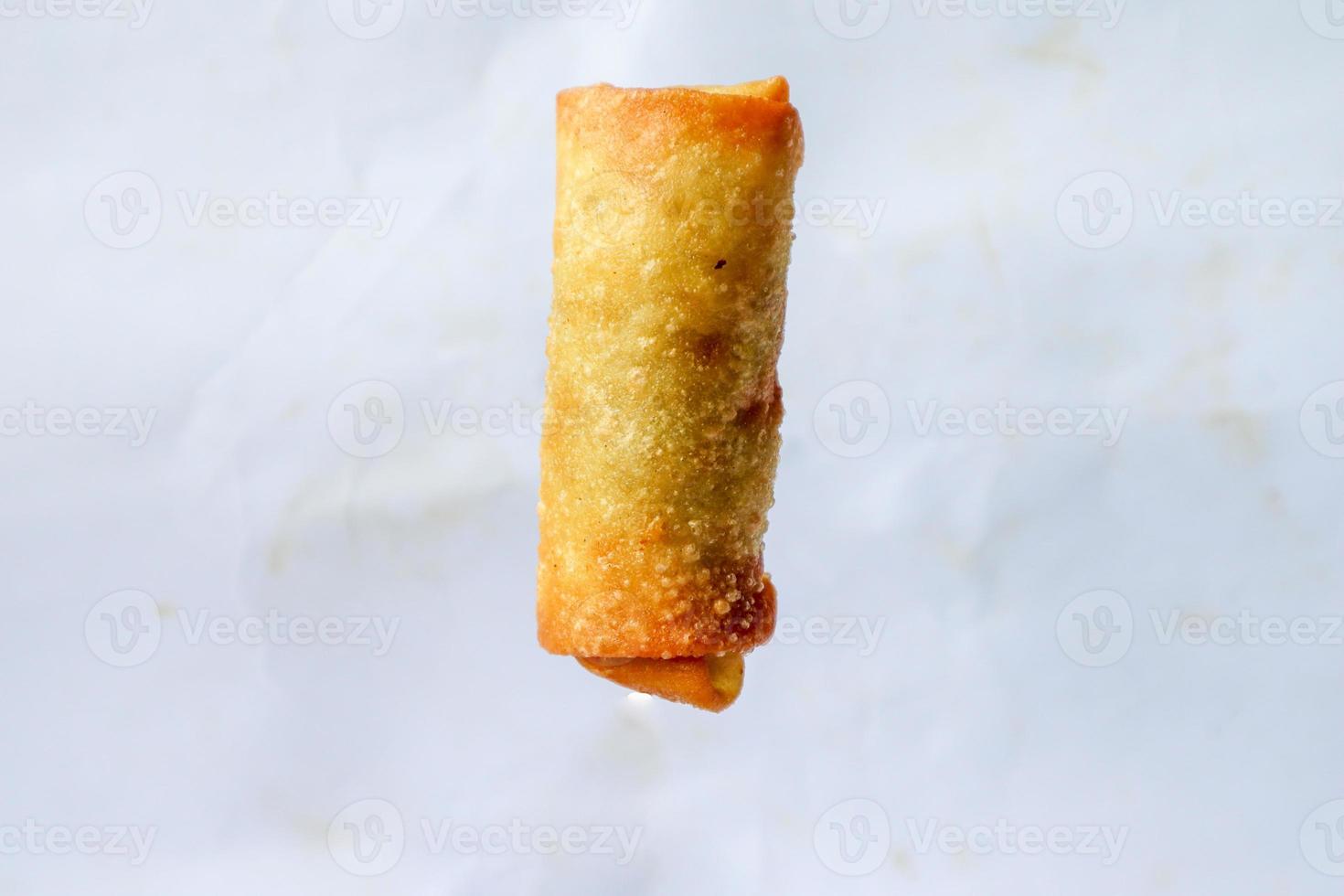 Lumpia or lunpia, is traditional spring roll skin snack from Semarang, Indonesia. Traditional Spring rolls made eggs, and chicken or shrimp, stir-fried bamboo shoots. isolated on white background photo