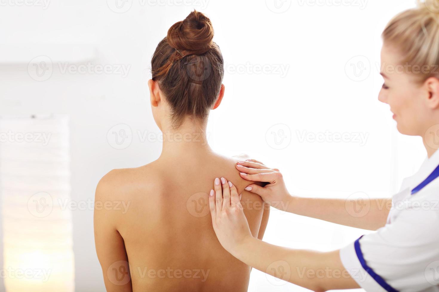 A picture of woman having back therapy photo