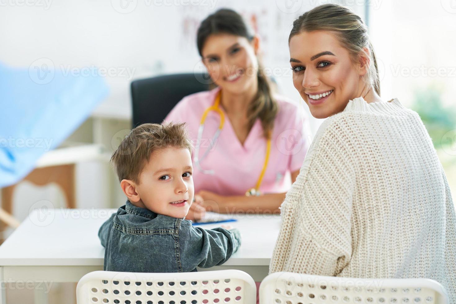 Little boy having medical examination by pediatrician photo