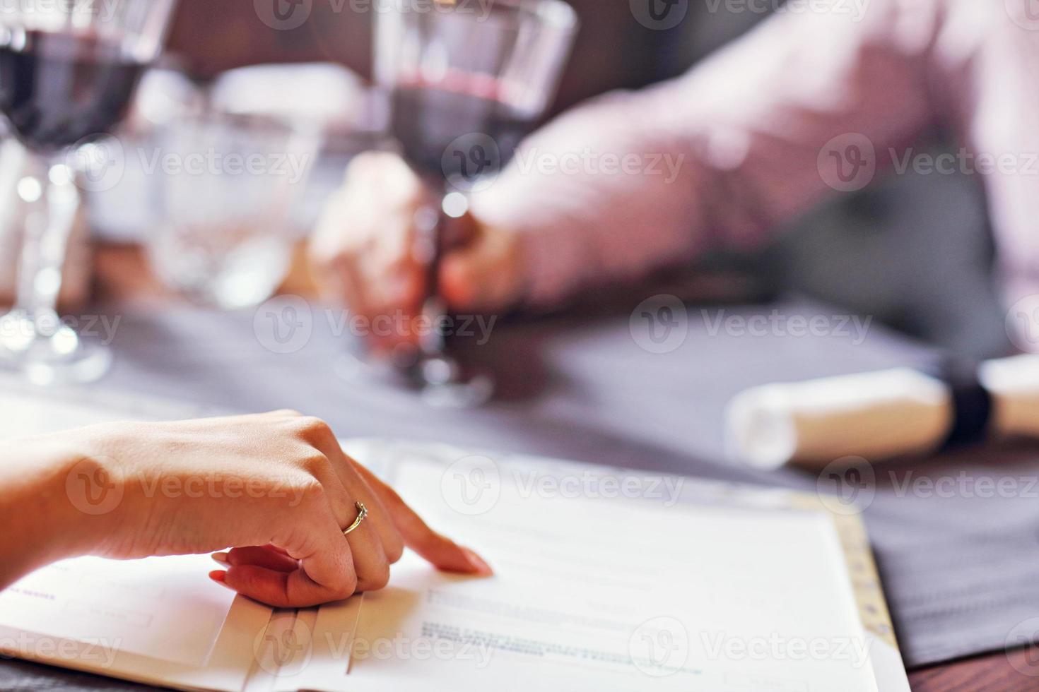 Romantic couple dating in restaurant and ordering from menu photo