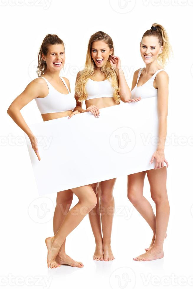 Group of happy friends posing in underwear with banner photo