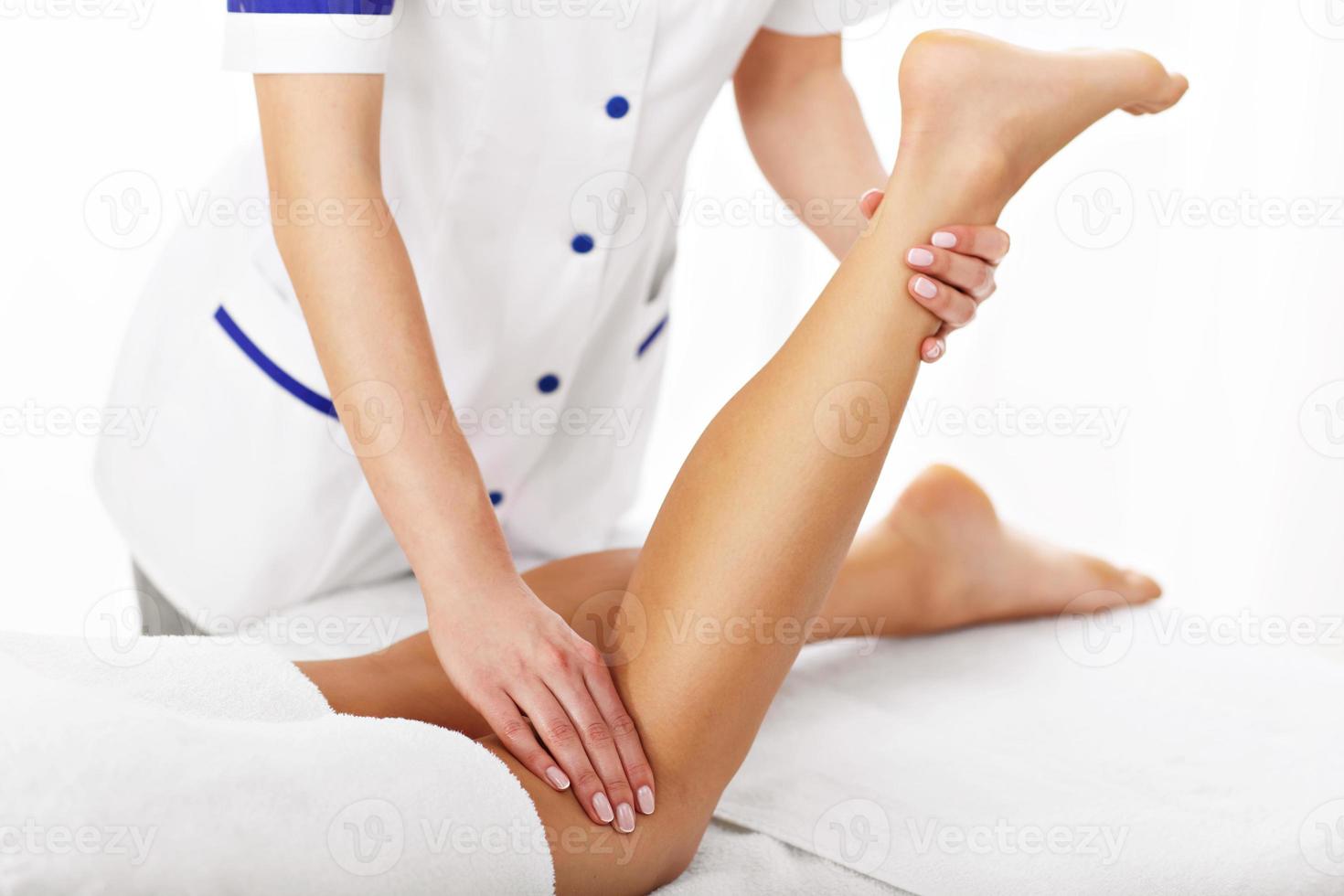 A picture of woman having leg therapy photo