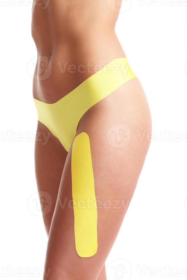 Picture showing special physio tape put on injured thigh photo