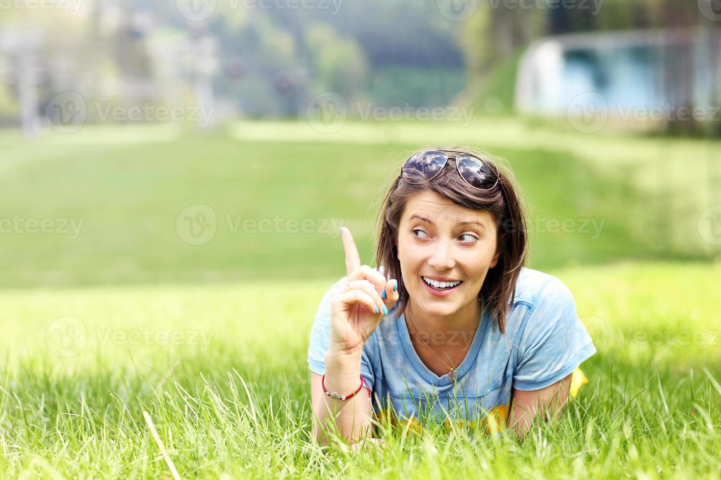 Young woman lying on the grass photo