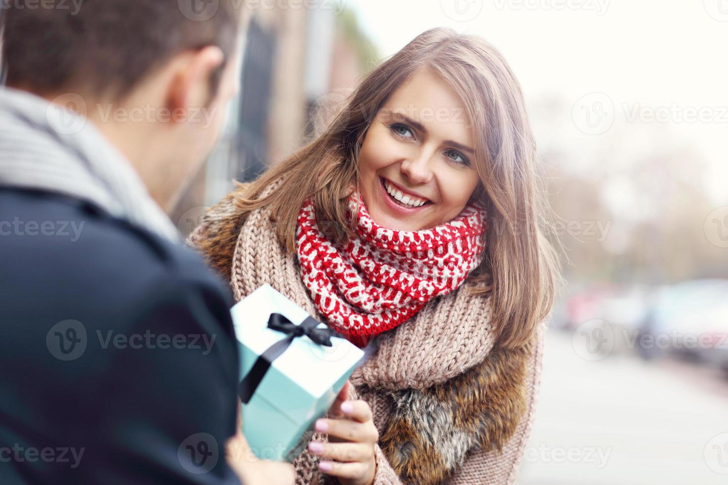 Young couple with present in the park photo