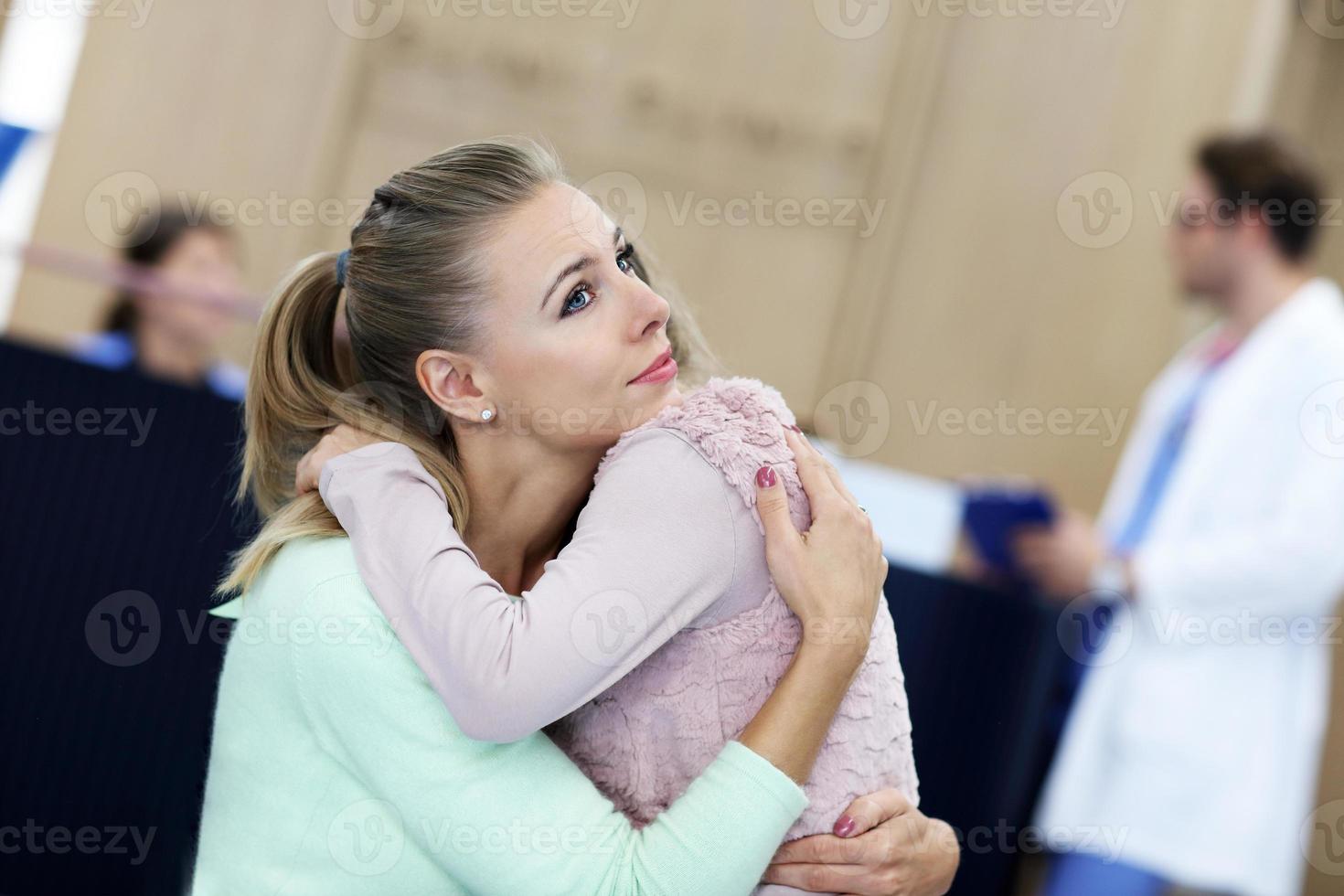 Little girl is crying while with her mother at a doctor on consultation photo