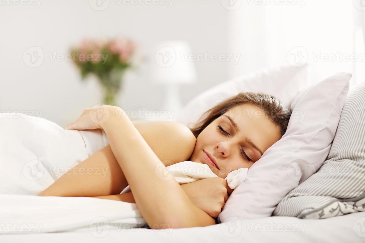 Young woman sleeping in bed photo