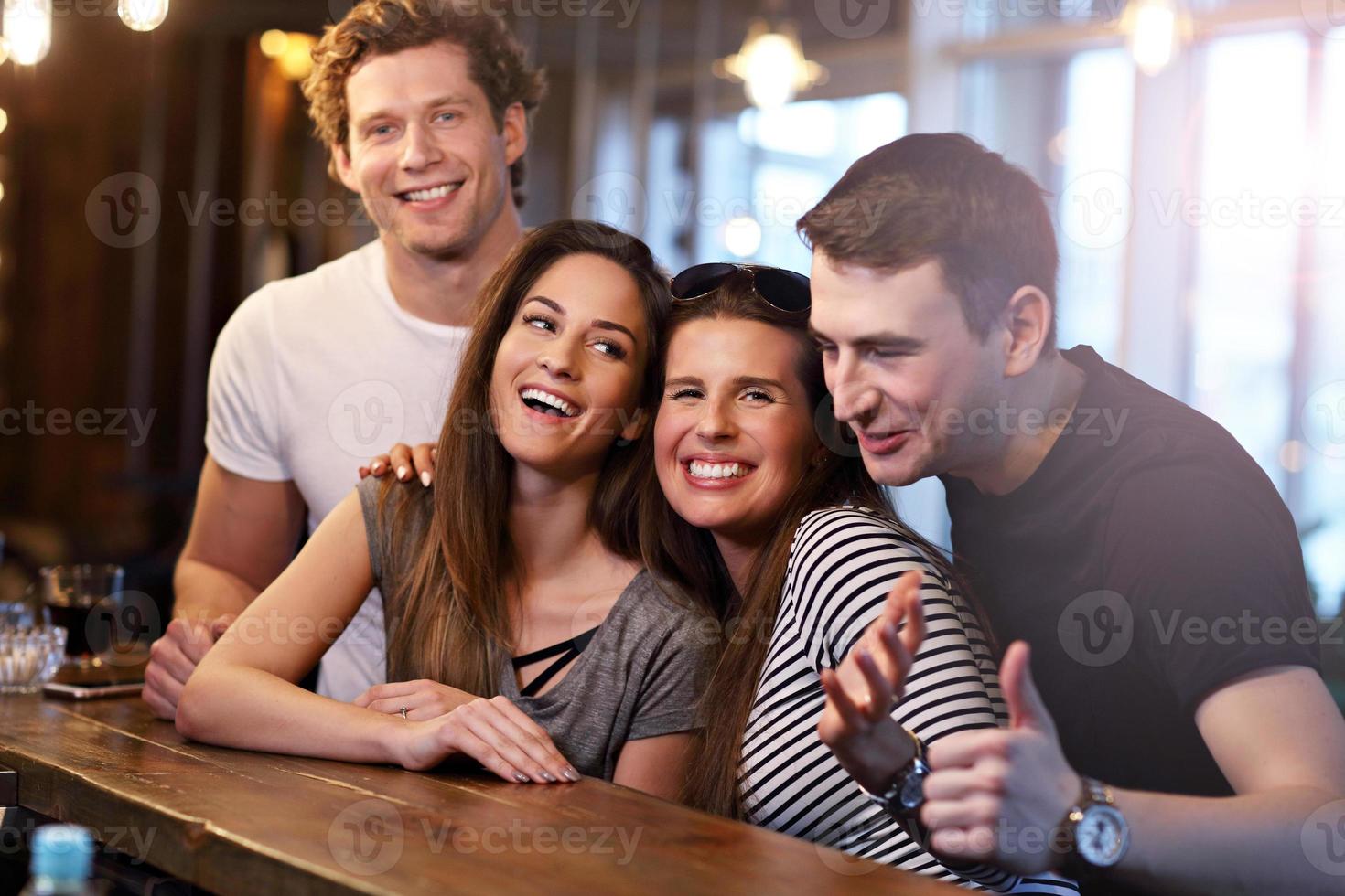 Group Of Friends Enjoying Meal In Restaurant photo