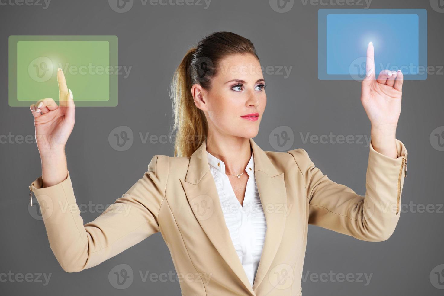 Businesswoman and touchscreen photo