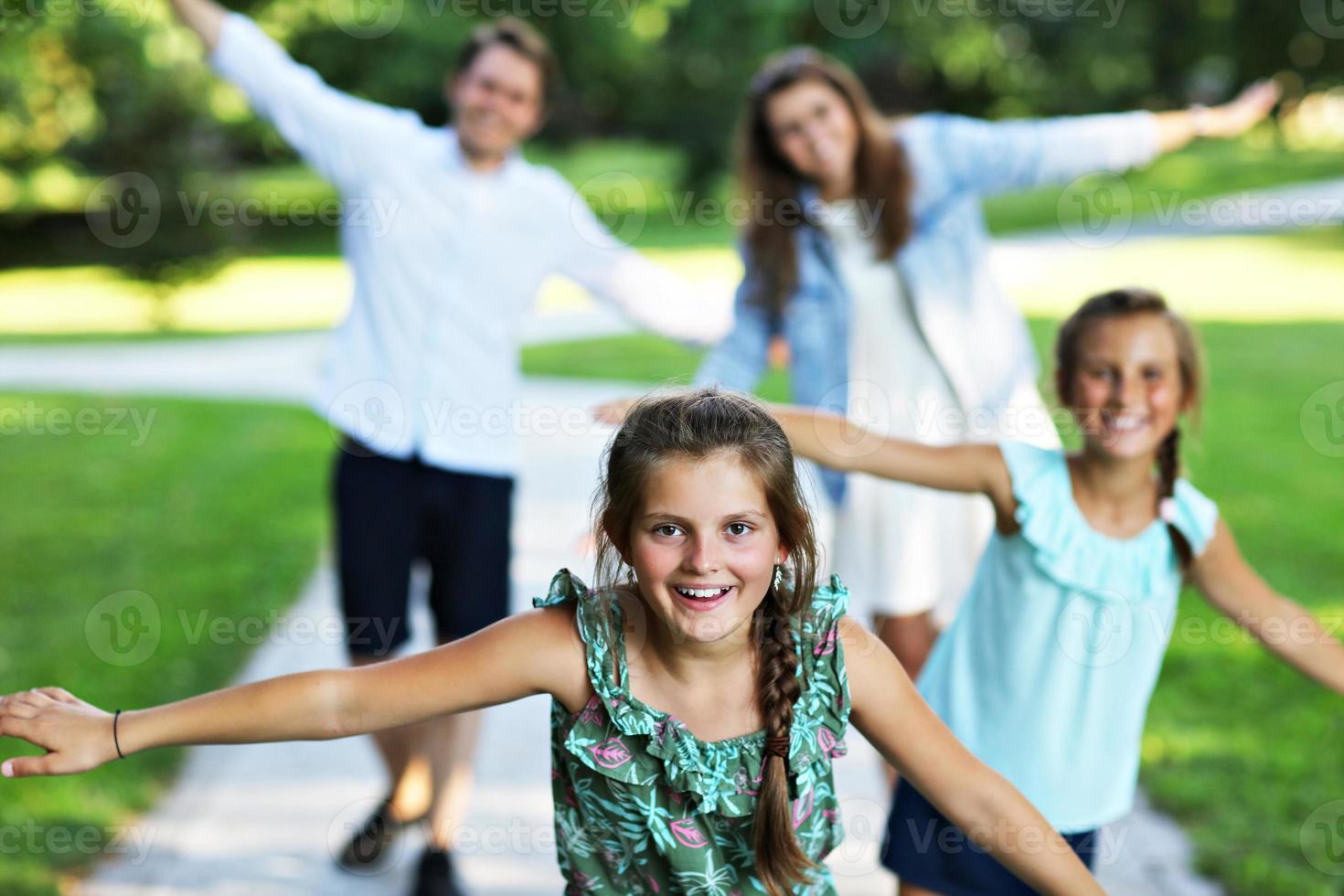 Young family with children having fun in nature photo