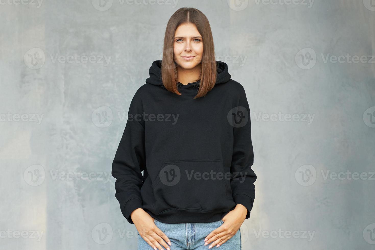 Young woman in black hoodie. photo