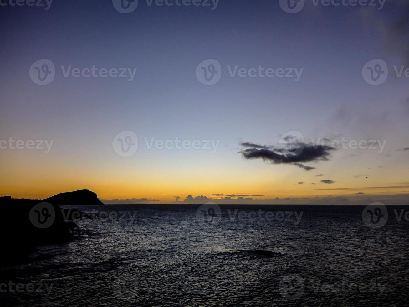 Sunset over the ocean photo