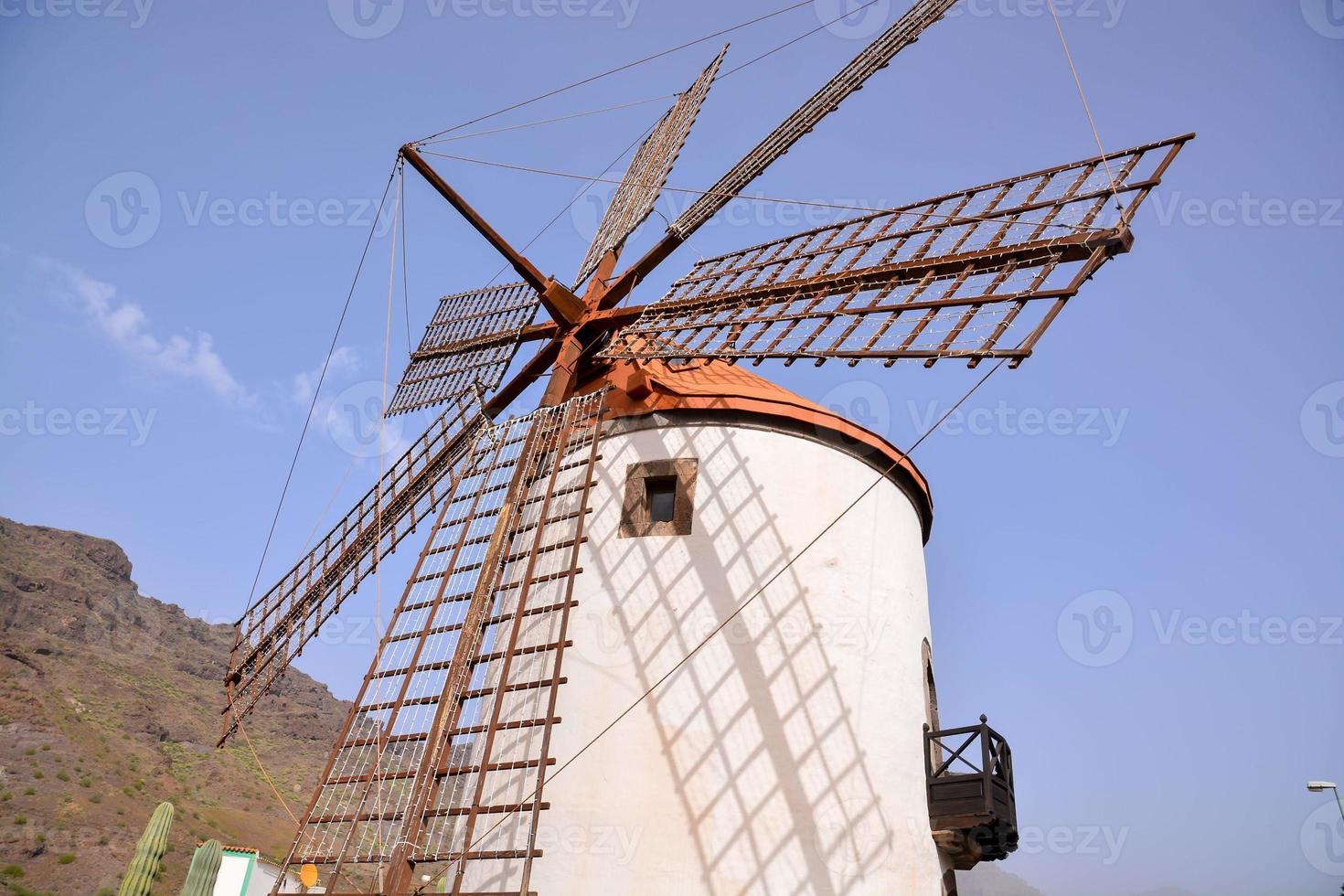 Traditional windmill under clear blue sky photo