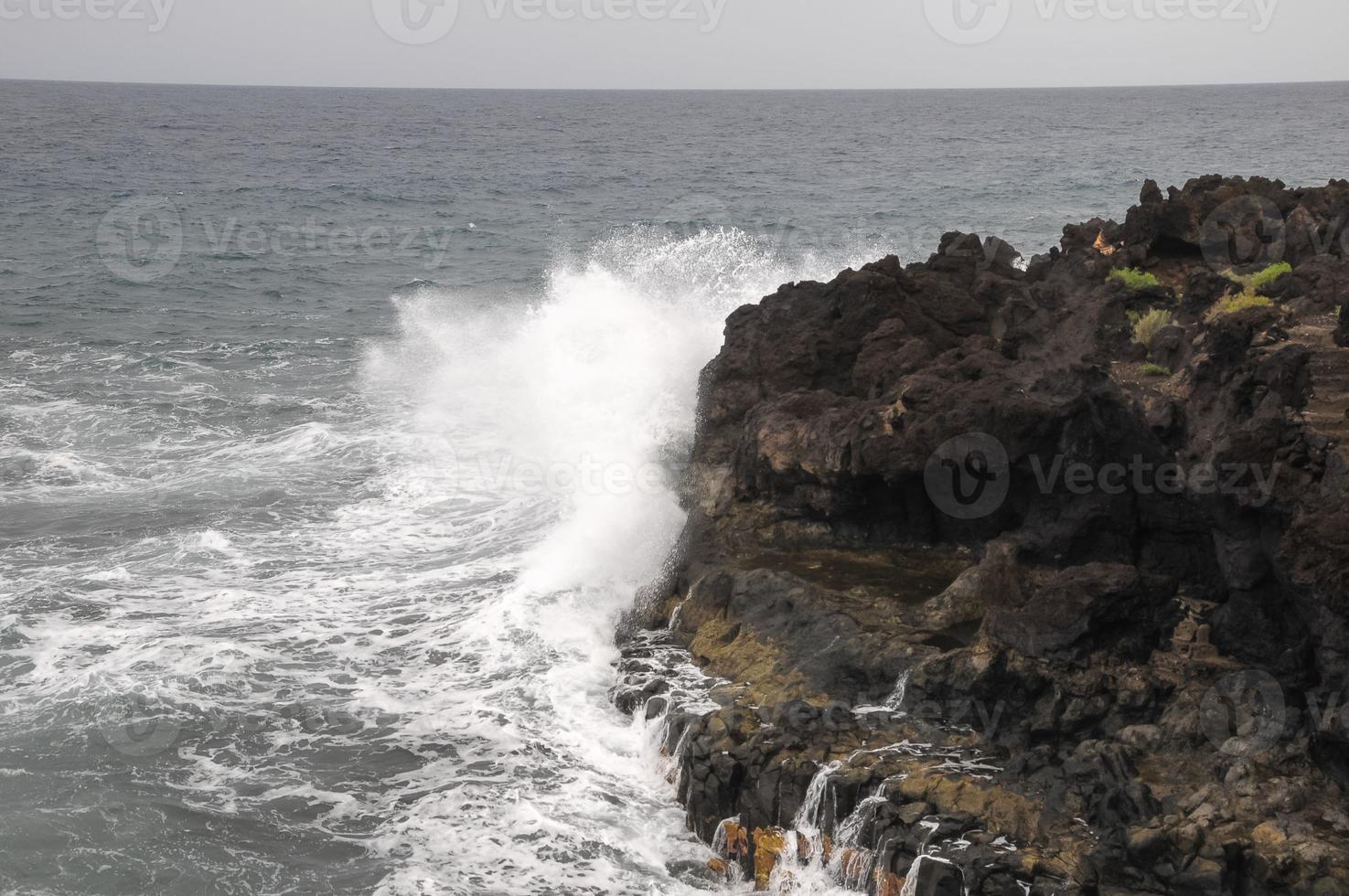 Strong Waves hitting the rocks photo