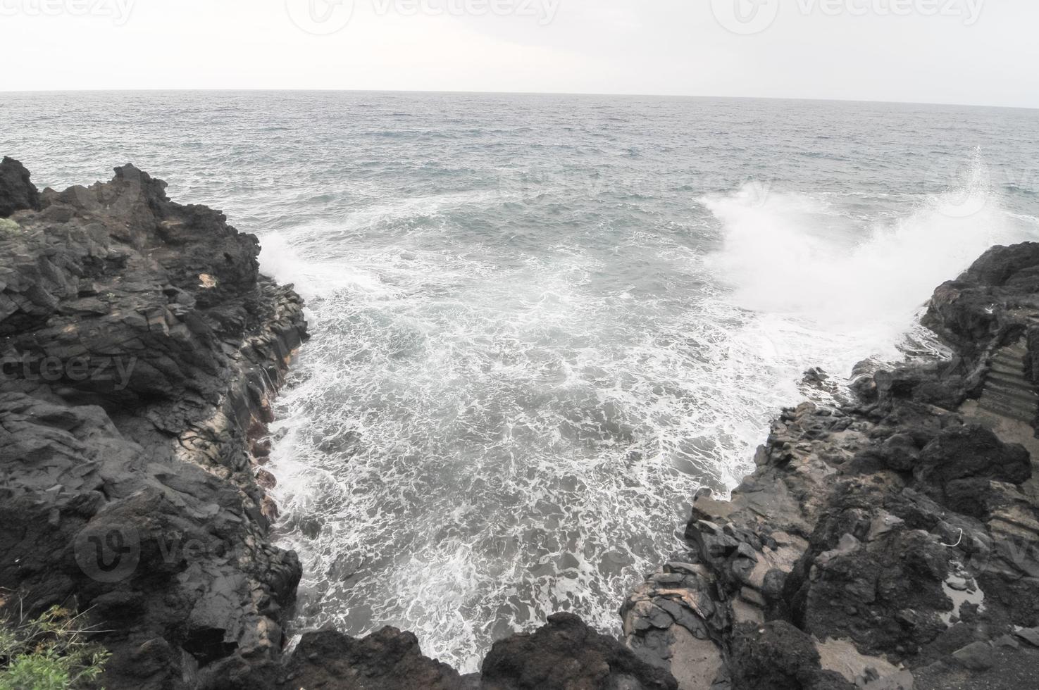 Strong Waves hitting the rocks photo