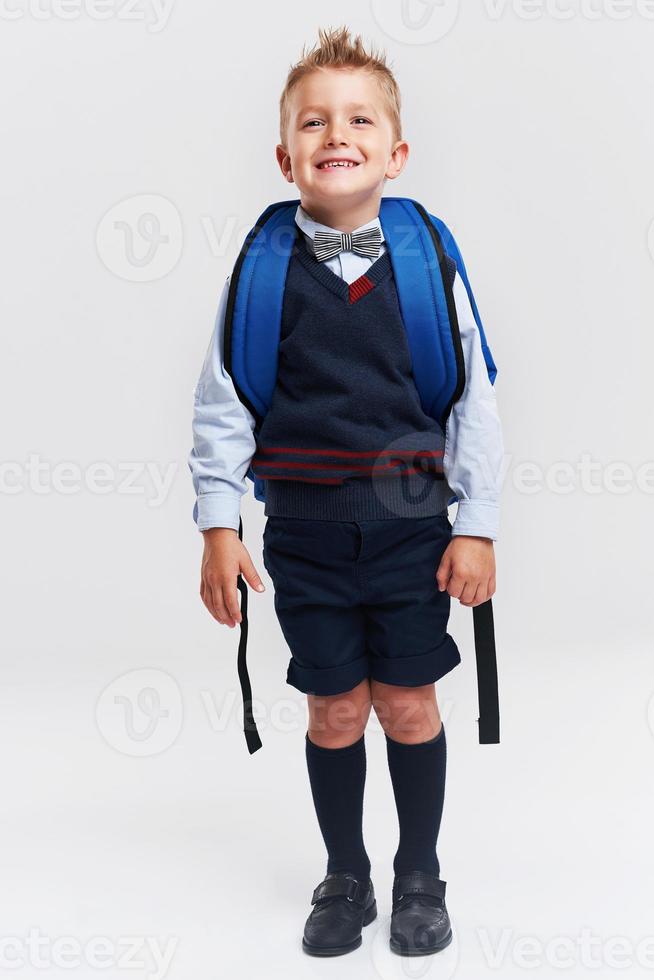 Portrait of a boy ready to school isolated on white photo