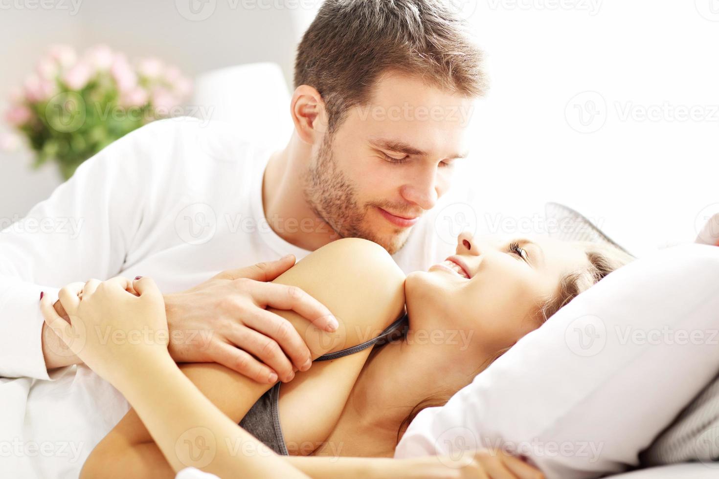 Young couple hugging in bed photo