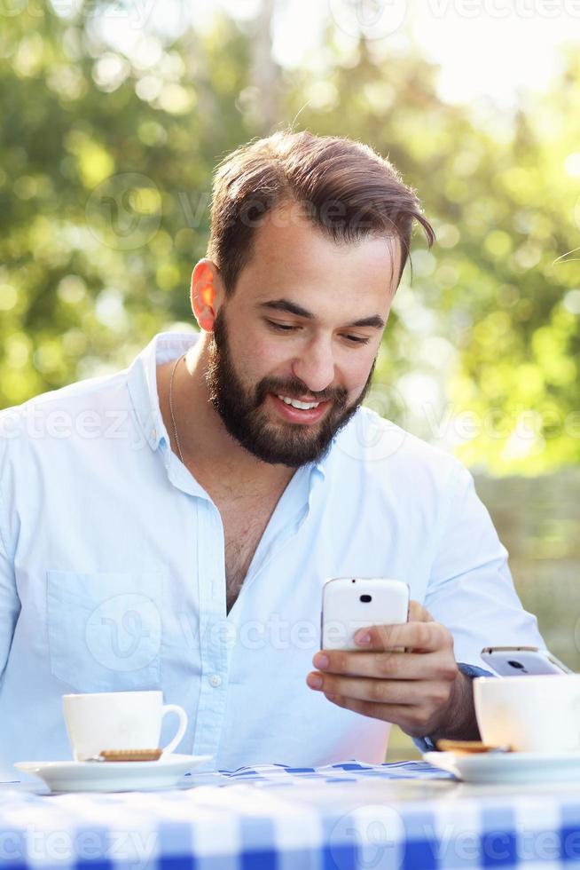 Man with smartphone in restaurant photo