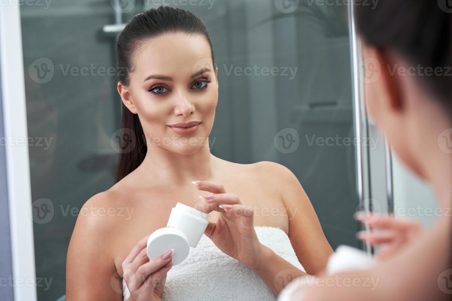 Woman looking on reflection in the mirror after shower 15851946 Stock
