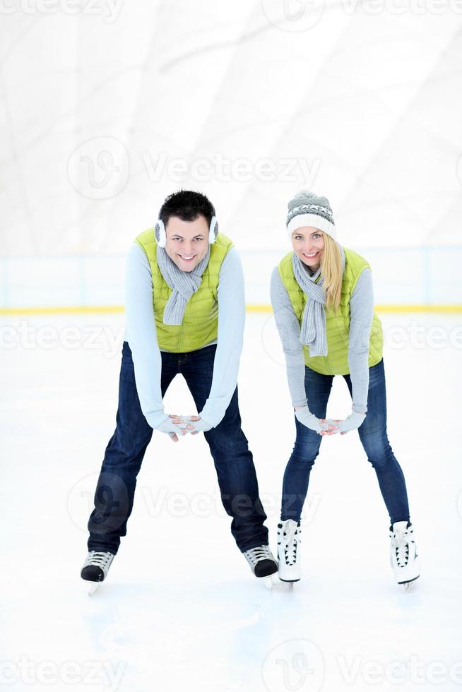 Cheerful couple on the skating rink photo