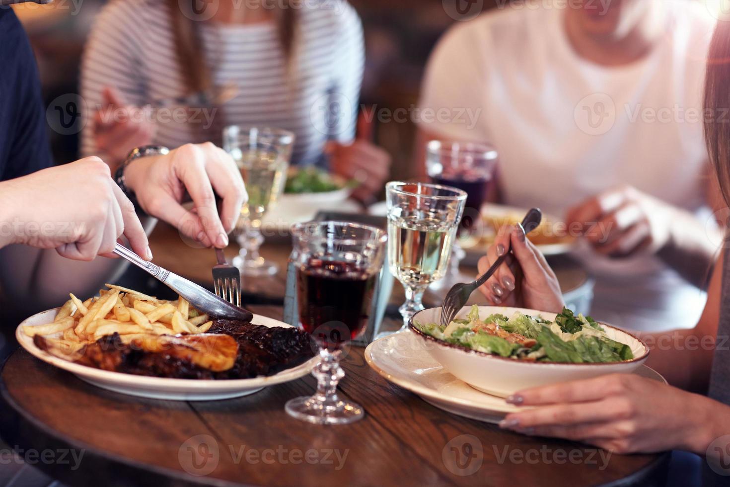 Group Of Friends Enjoying Meal In Restaurant photo