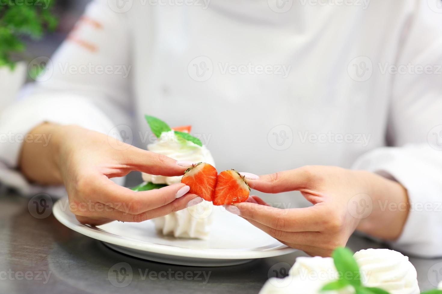 Busy chef at work in the restaurant kitchen photo