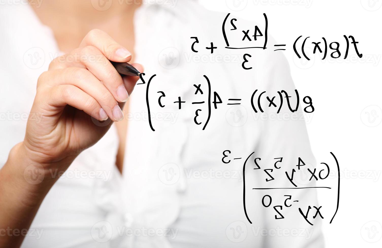 Toung teacher solving a mathematical equation photo