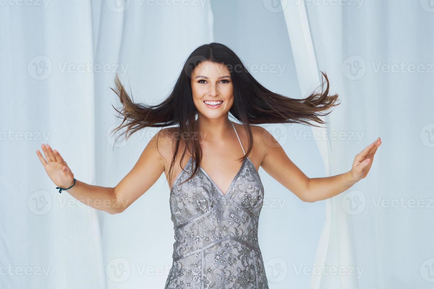 Woman in clothes store in changing room wearing dress photo