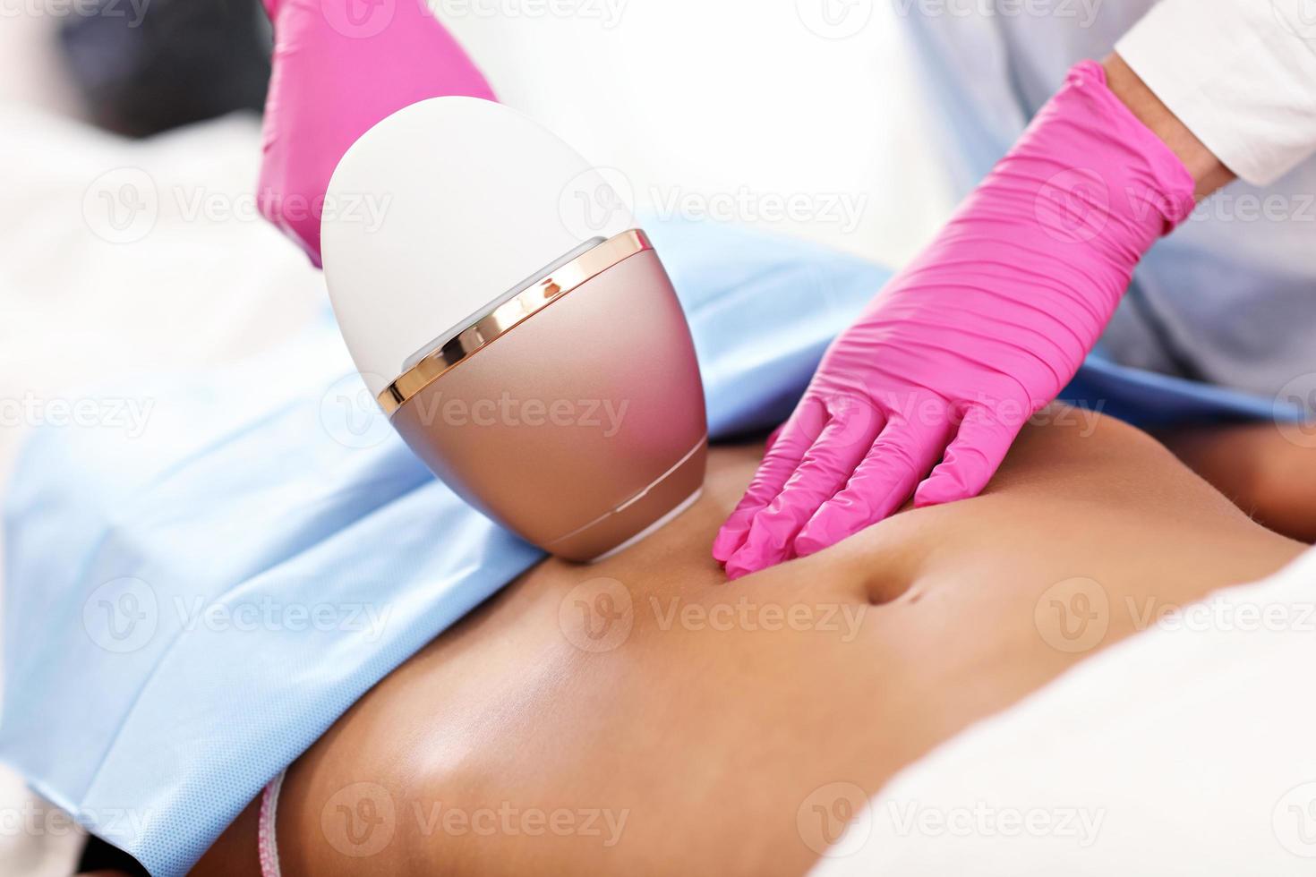 Adult woman having laser hair removal in professional beauty salon photo