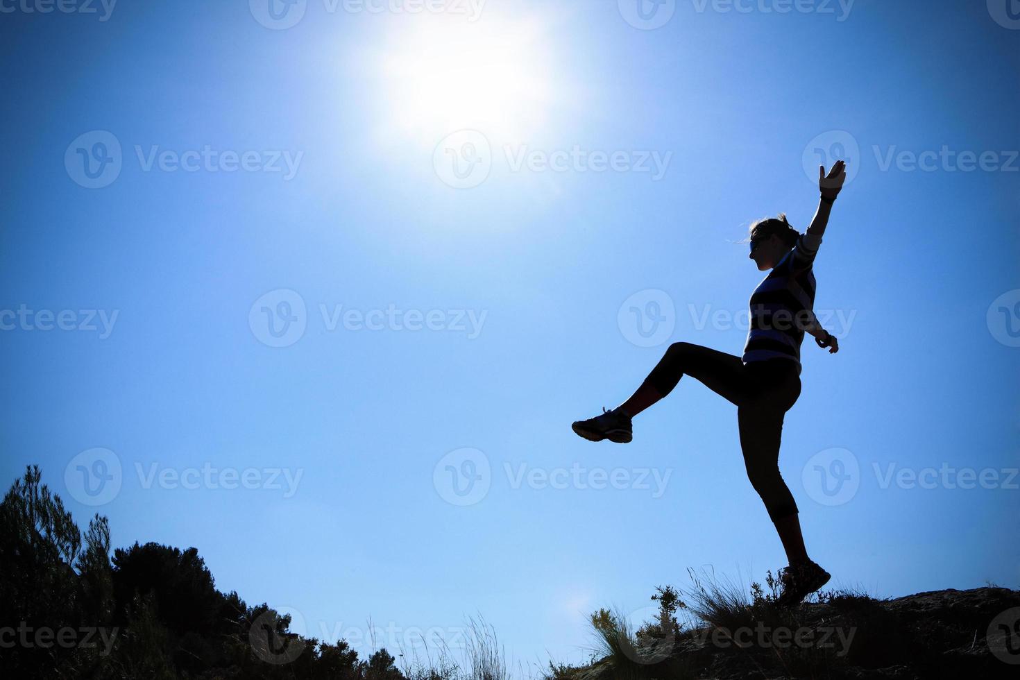 Young woman walking in the sun photo