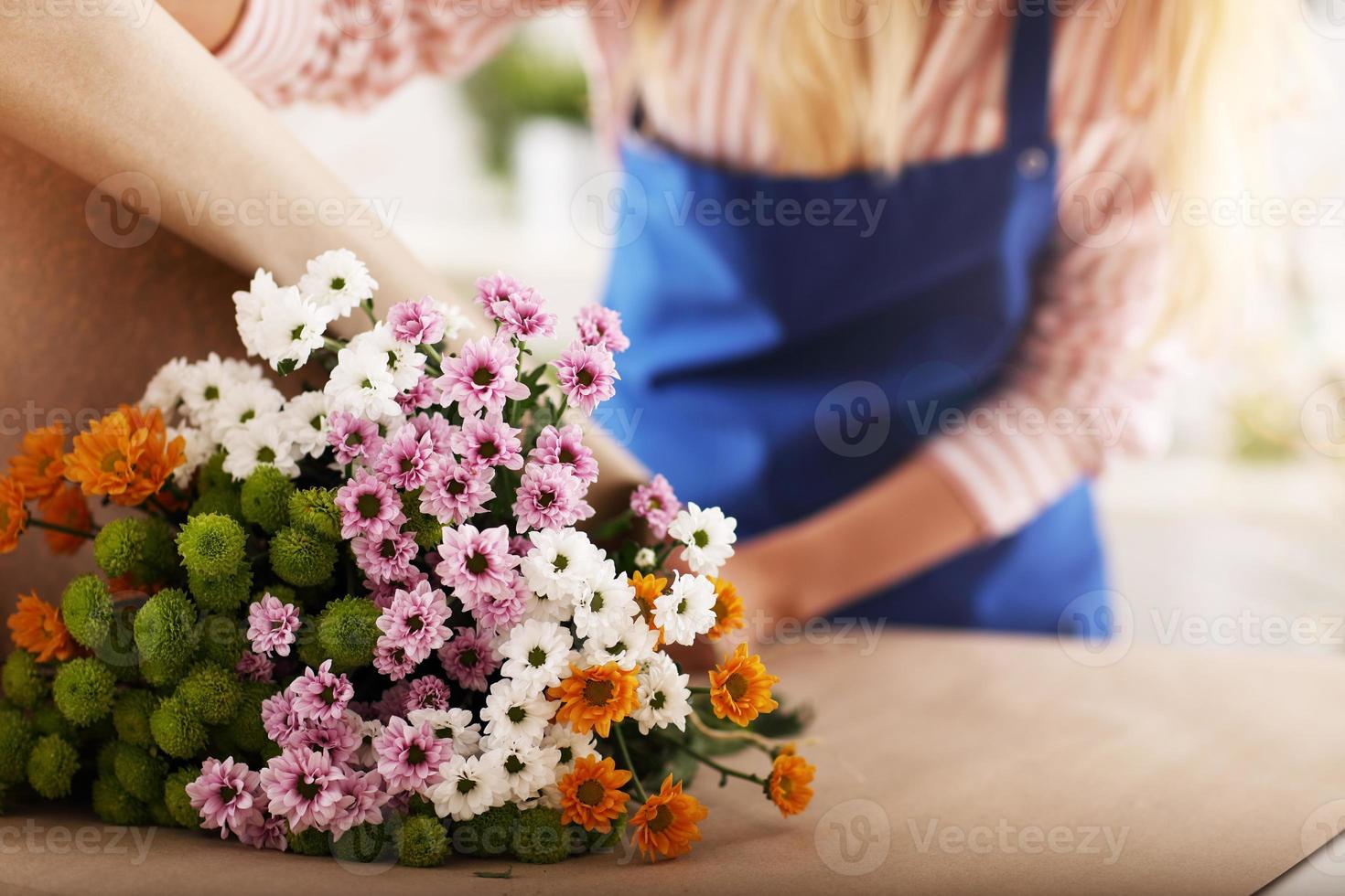 Female florist working in flower shop photo