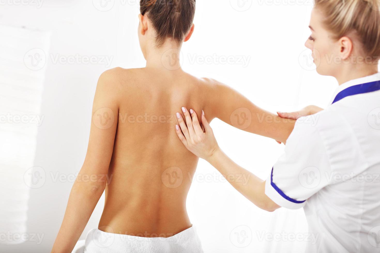 A picture of woman having back therapy photo