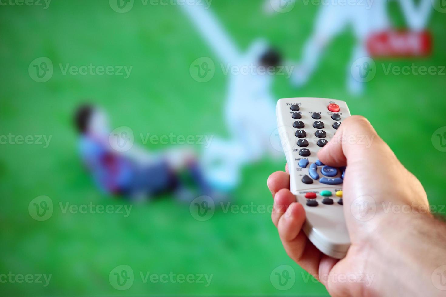 Male hand holding a remote control photo
