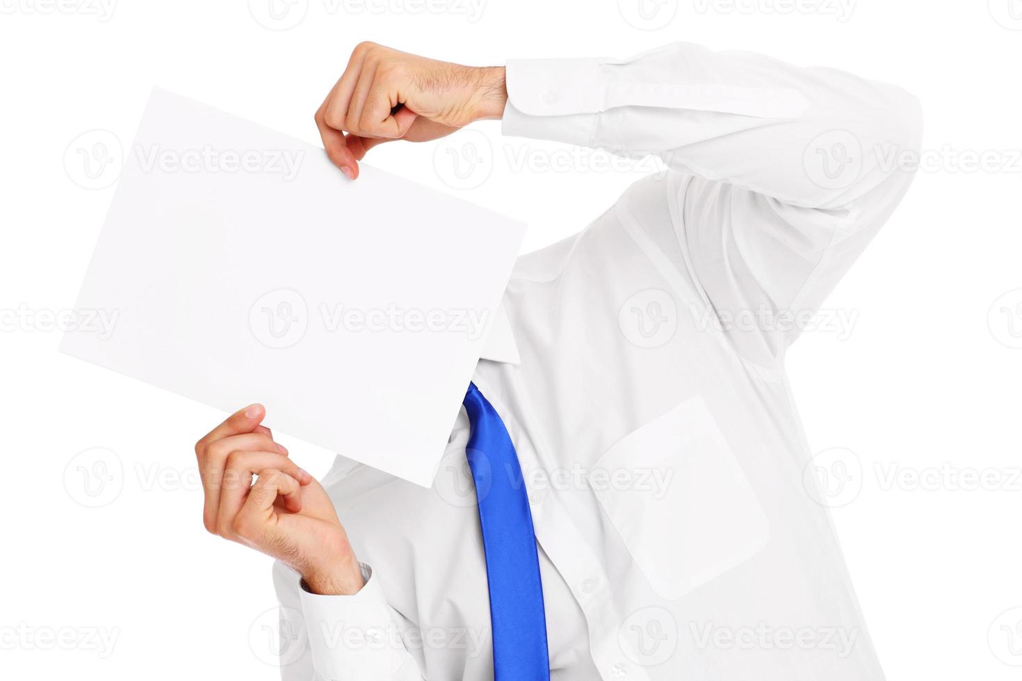 Businessman covering his face with a paper photo