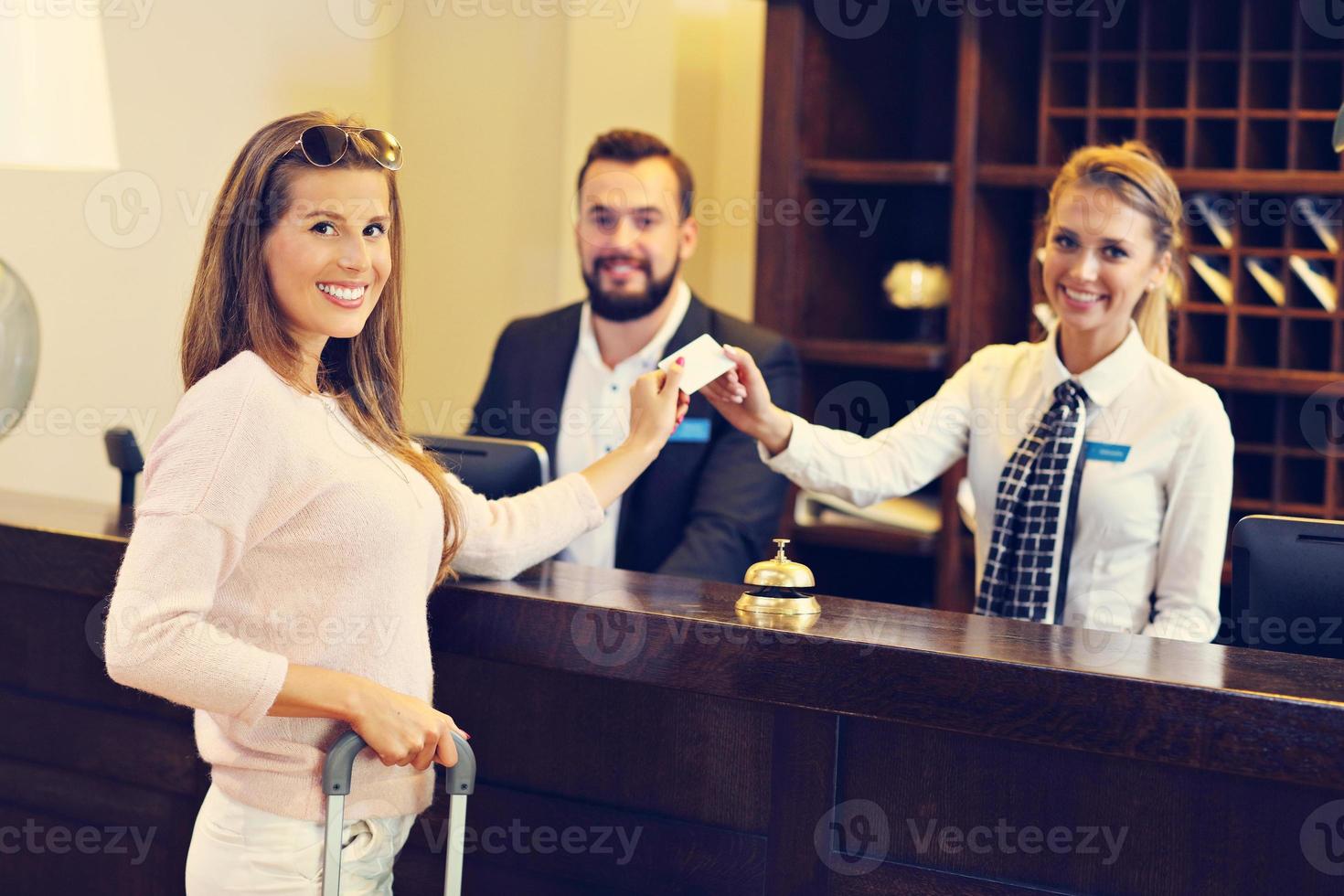 Woman at reception desk in hotel photo