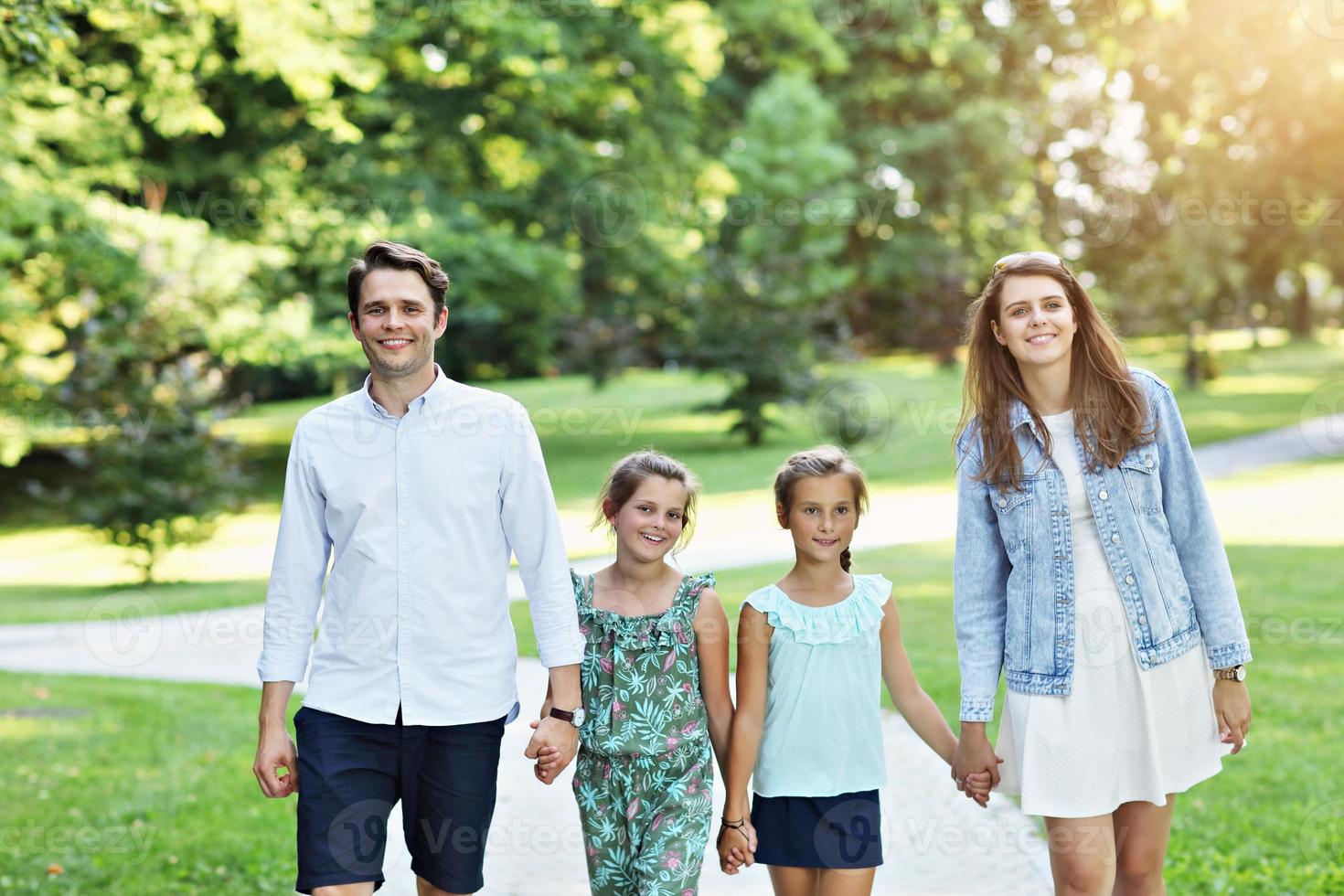 Young family with children having fun in nature photo