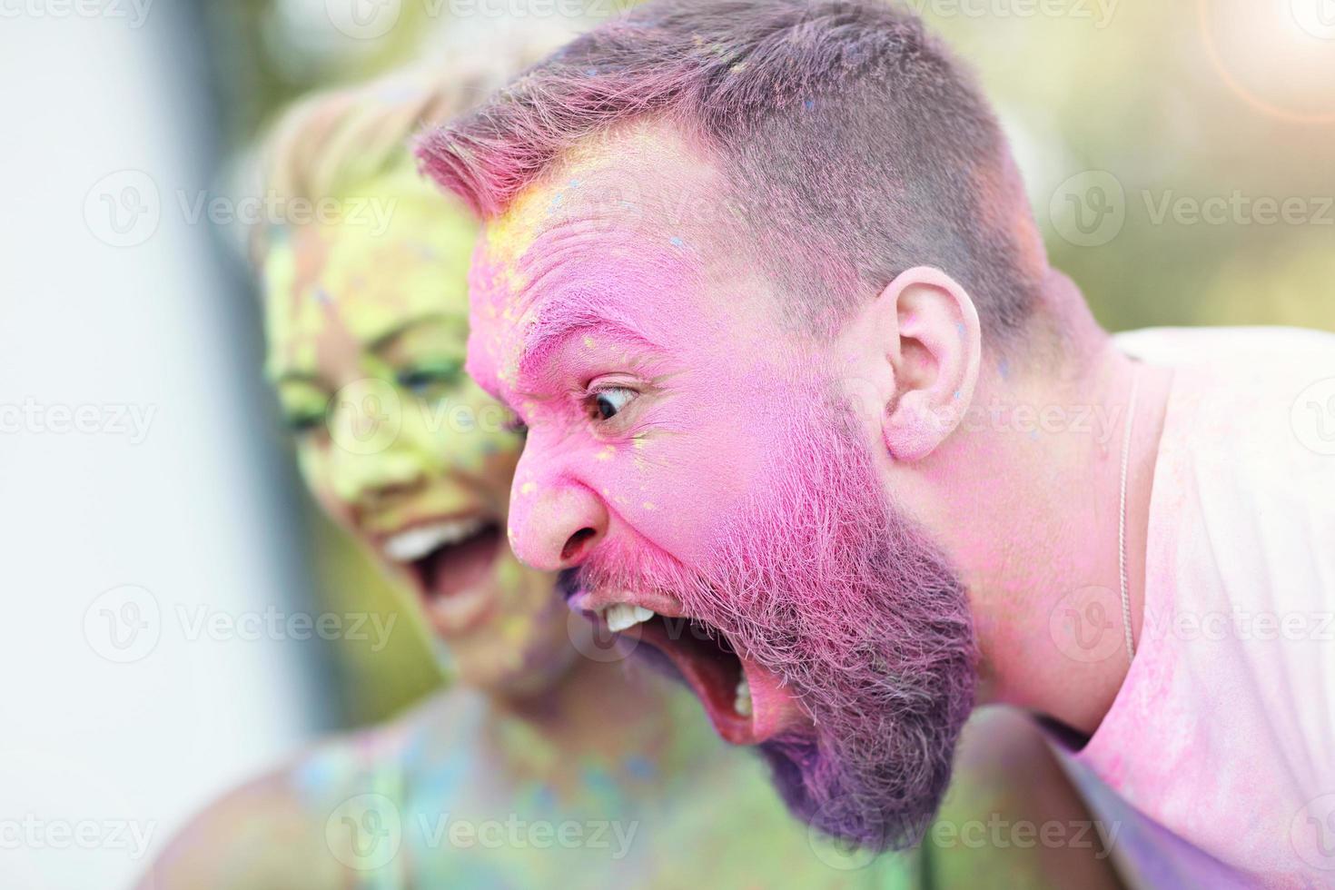 Group of friends having fun at color festival photo