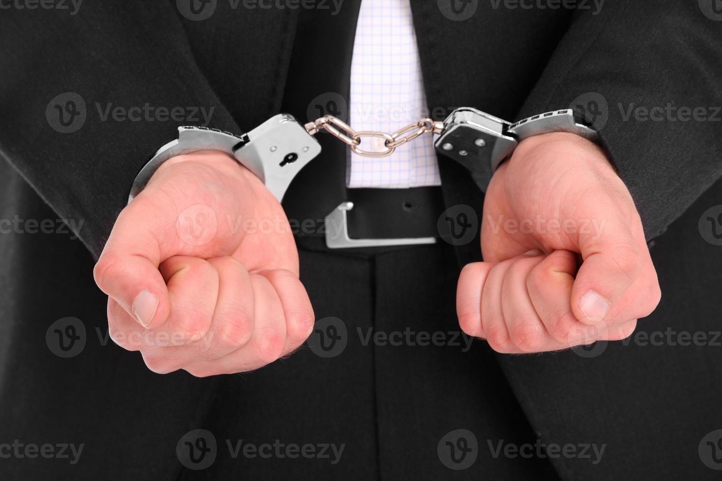 Man in suit handcuffed photo