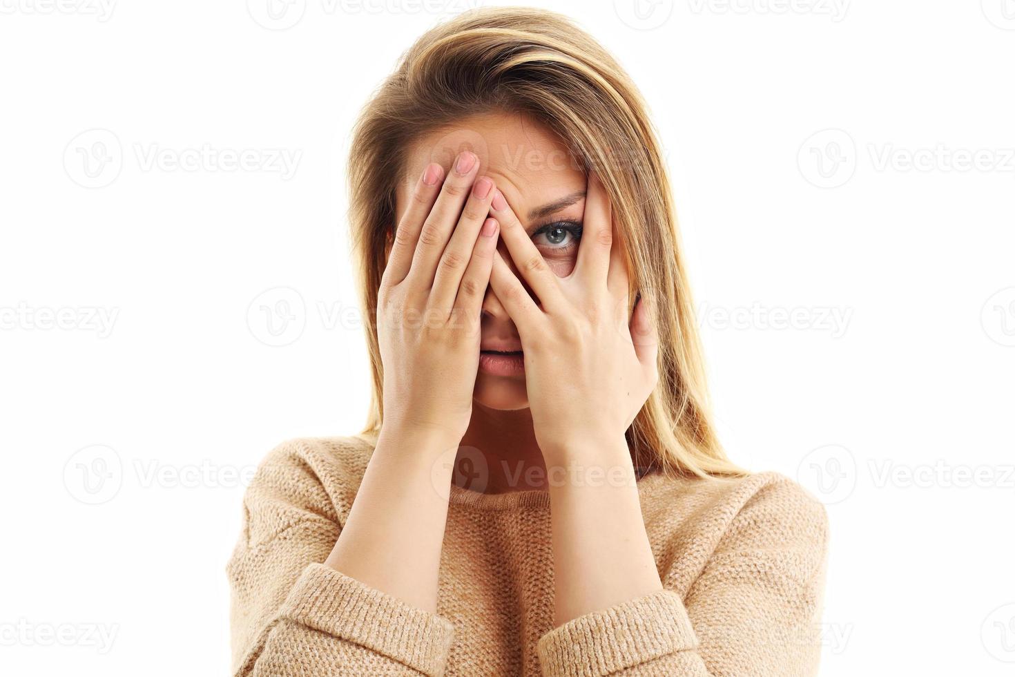 Afraid woman looking at camera isolated on a white background photo
