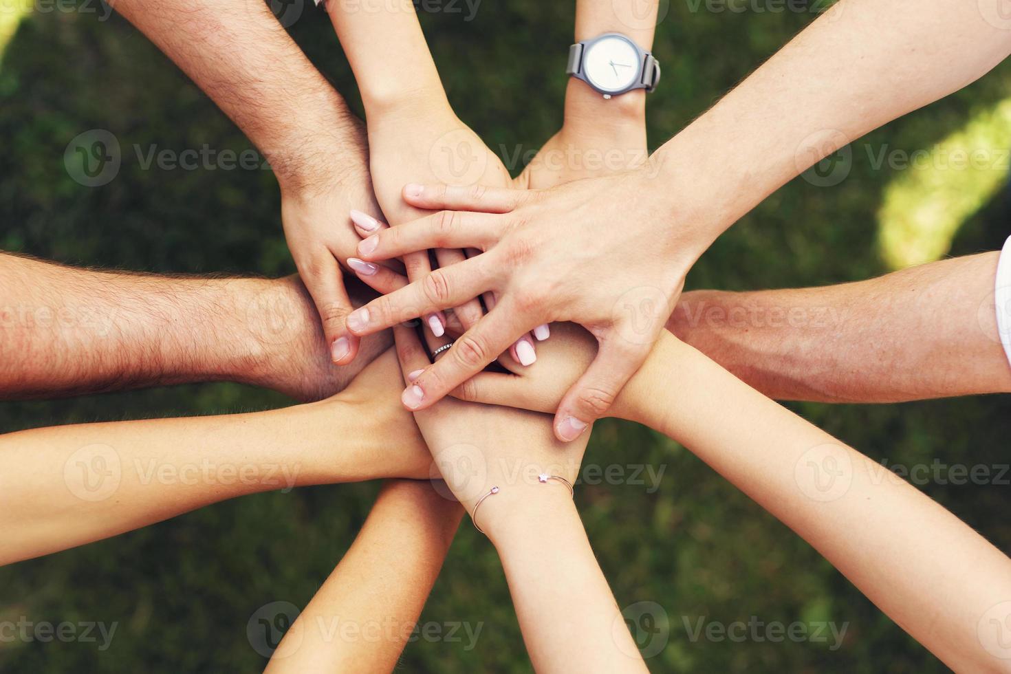 Group of friends bonding hands together photo