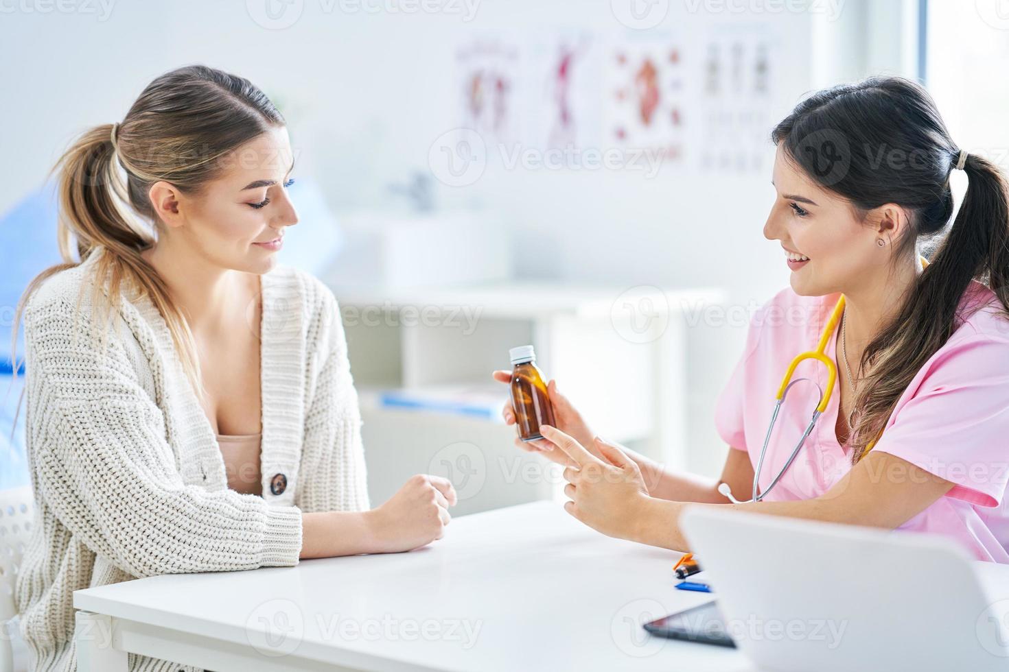 Doctor explaining diagnosis to her female patient photo