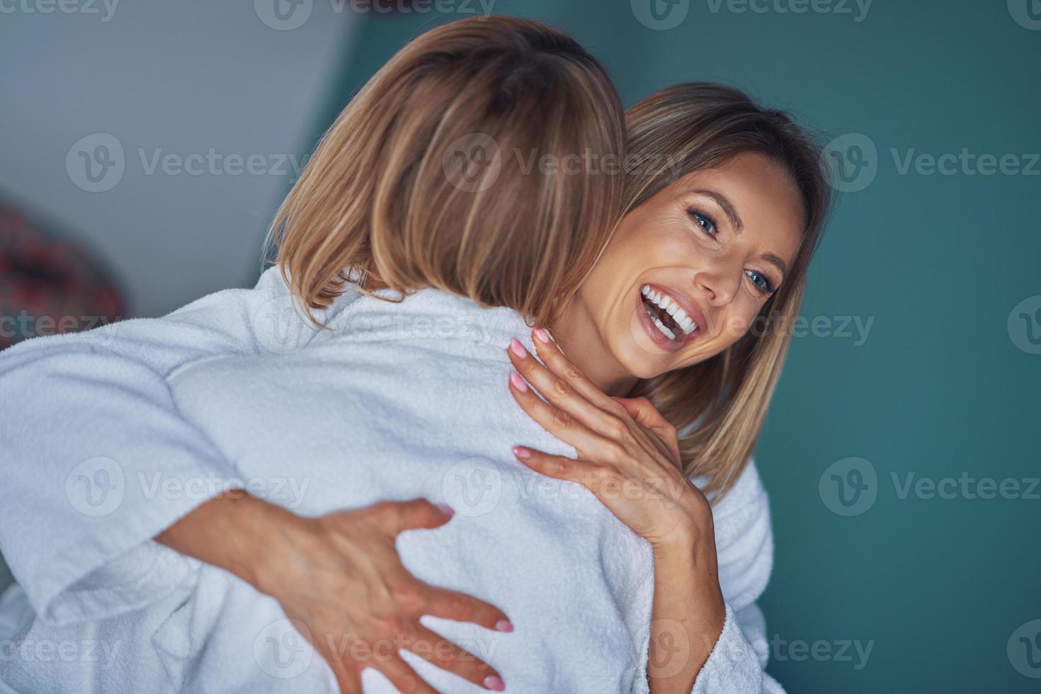 Two girl friends or couple in bedroom having fun photo